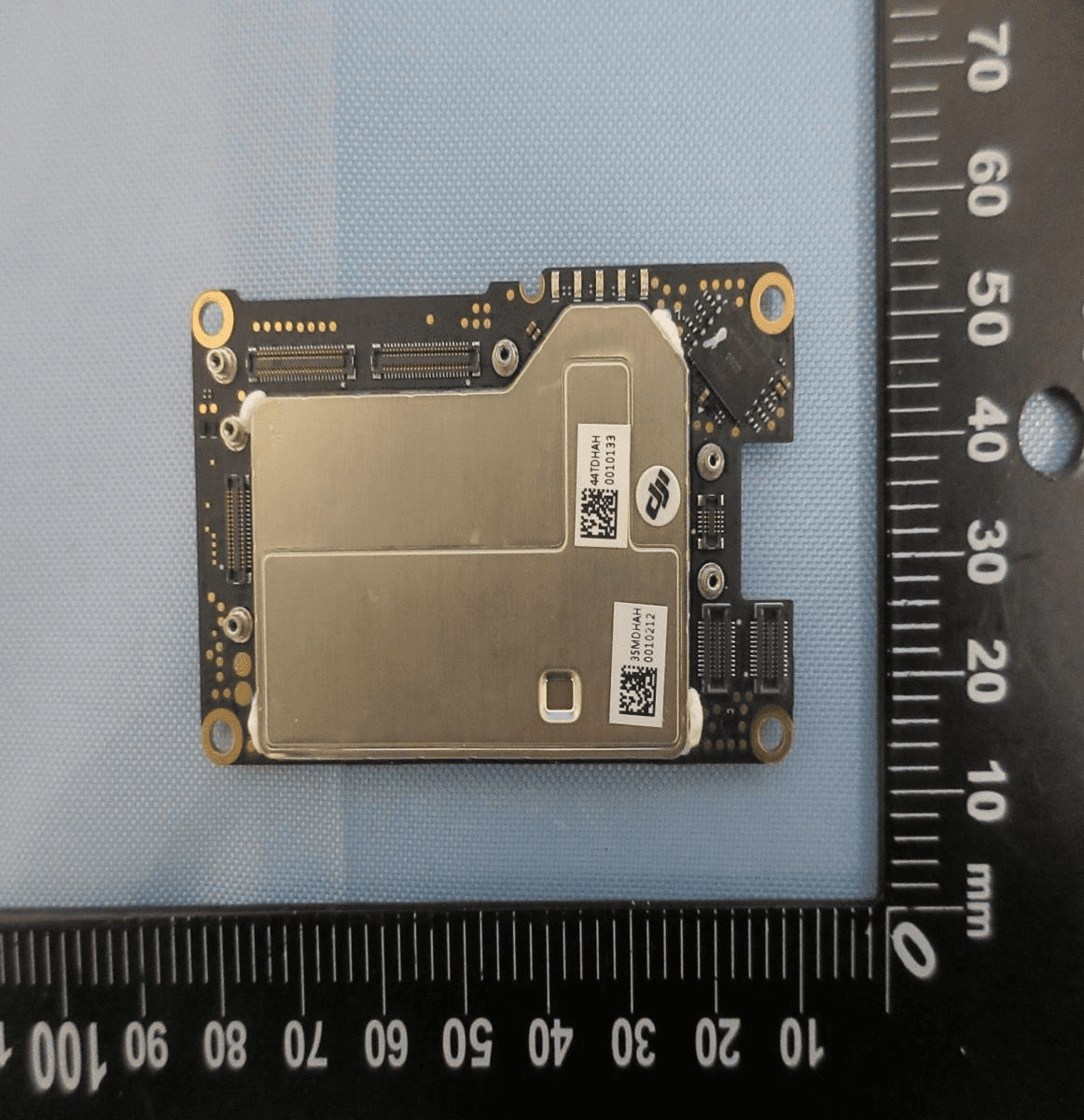 Densely populated PCB with major EMI shield and modular connectors.