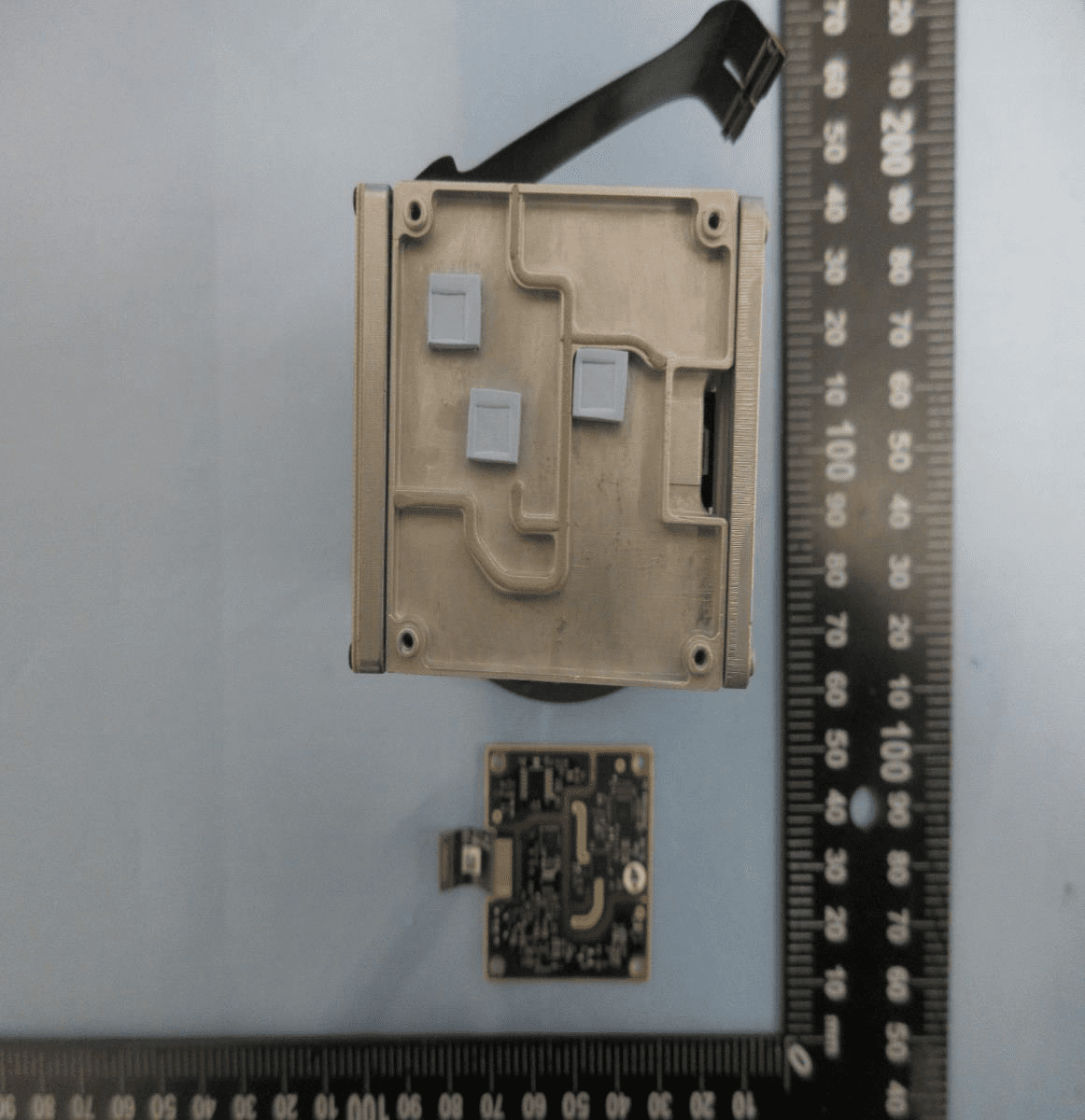 Shielded PCB with flex connector and thermal pads for robust sensor or control tasks.