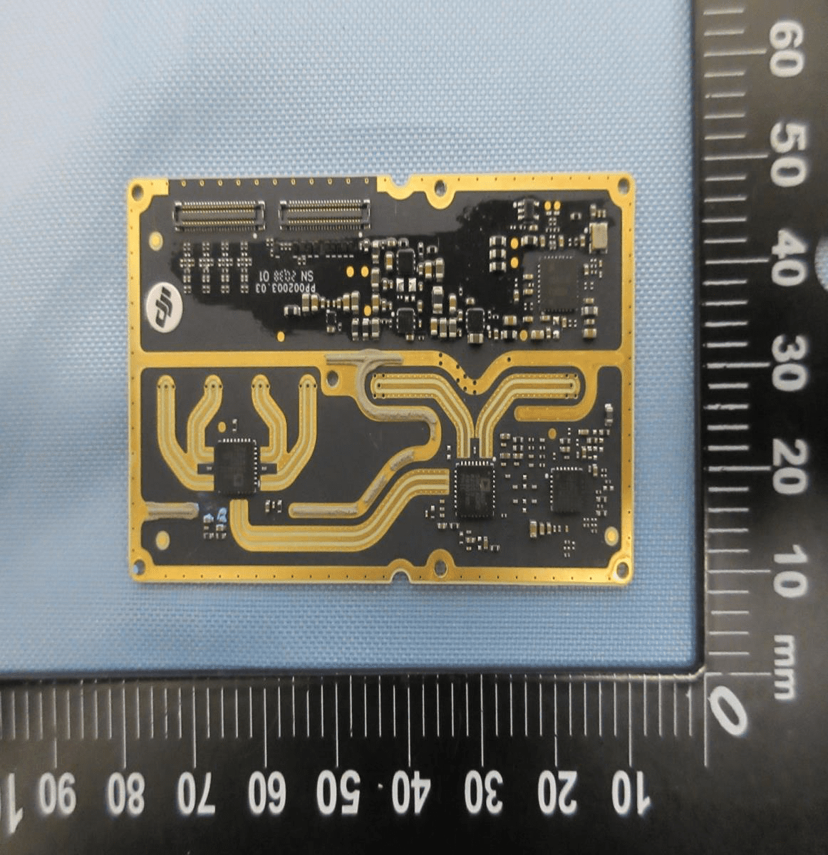 PCB with integrated trace antenna and high-density ICs for wireless communication.