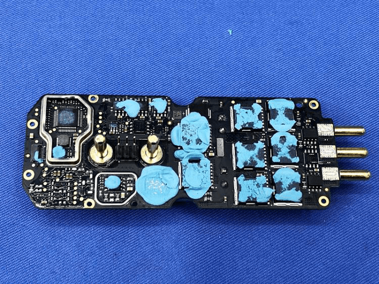 Motor controller PCB with thermal pads and shielded MCU section.