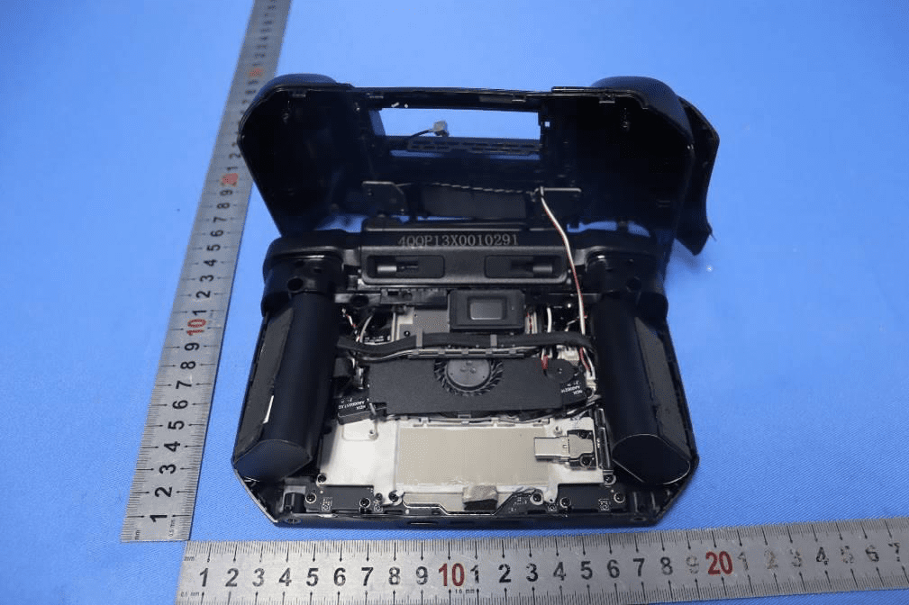Internal overview with battery cells, fan, and modular PCB assembly.