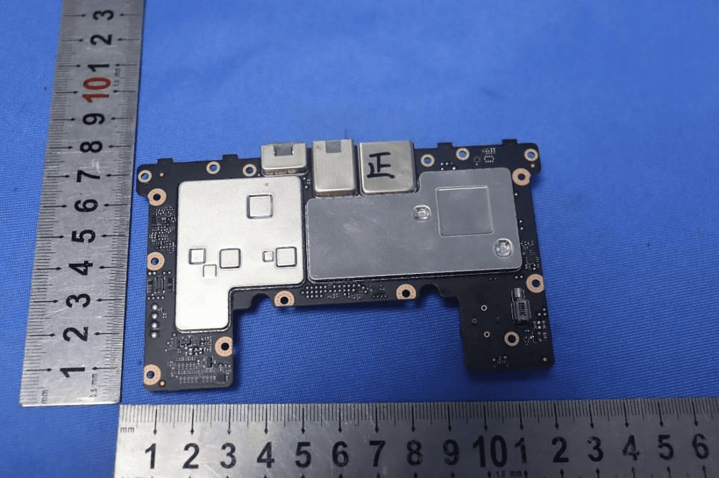 PCB close-up with EMI shields and FPC connectors for display/interface.