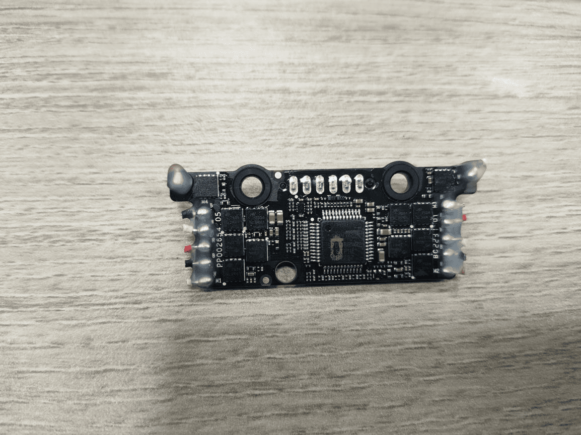 Main PCB with QFP microcontroller, motor drivers, and reinforced connectors.