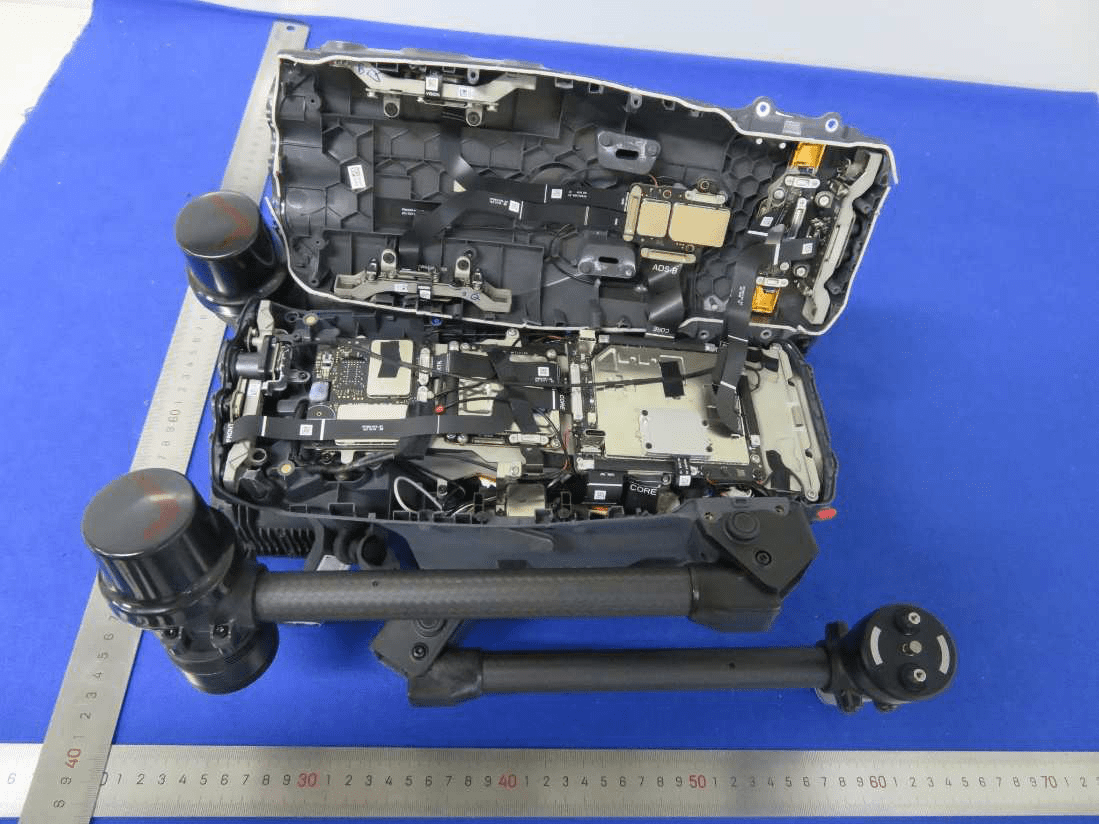 Main drone PCB with SoC, memory, RF transceivers, and extensive shielding.