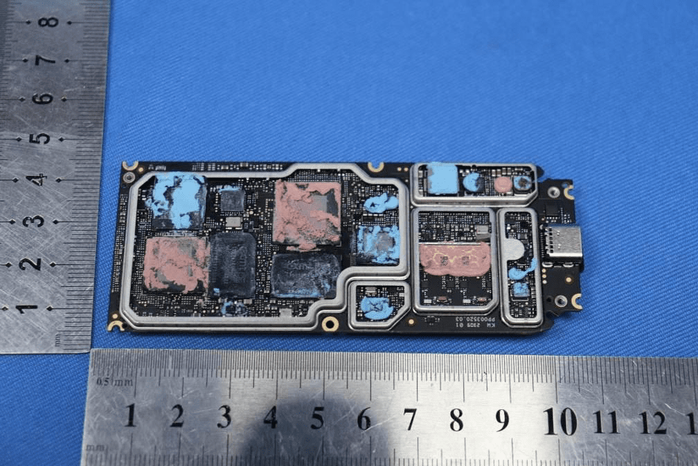 Main logic board with SoC, memory, and RF circuitry under dense shielding.