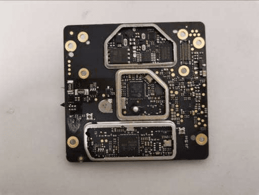 Densely populated PCB with shielded microcontroller and RF sections.