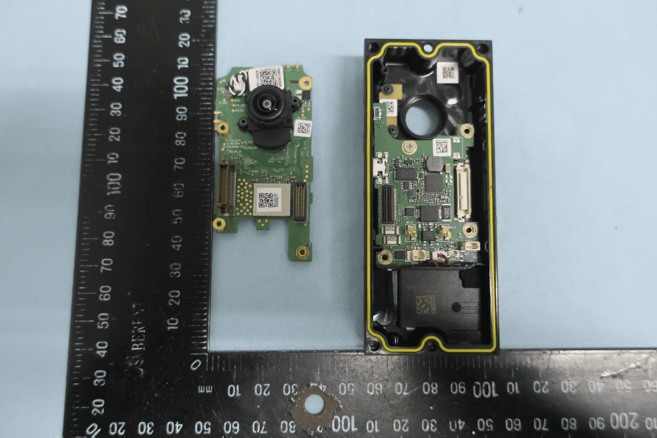 Dual-PCB assembly with camera module and main processing board.